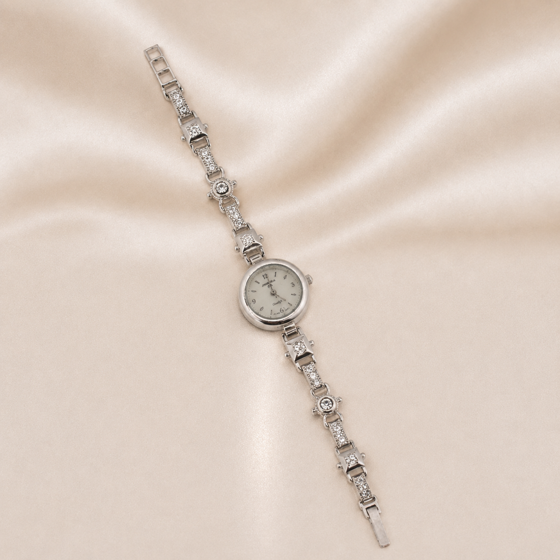 Silver bracelet watch with diamond accents on a beige fabric background Sterling Silver | Argento .925 Quartz Watch Bracelet
