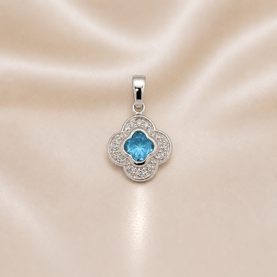 Silver pendant with a blue gemstone on a satin background Sterling Silver | Blue Clover CZ Pendant