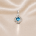 Silver pendant with a blue gemstone on a satin background Sterling Silver | Blue Clover CZ Pendant