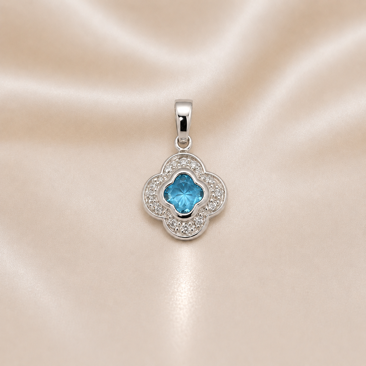 Silver pendant with a blue gemstone on a satin background Sterling Silver | Blue Clover CZ Pendant