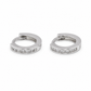 A pair of silver huggie hoop earrings with a row of clear pavé-set stones along the front, displayed on a clean white background.