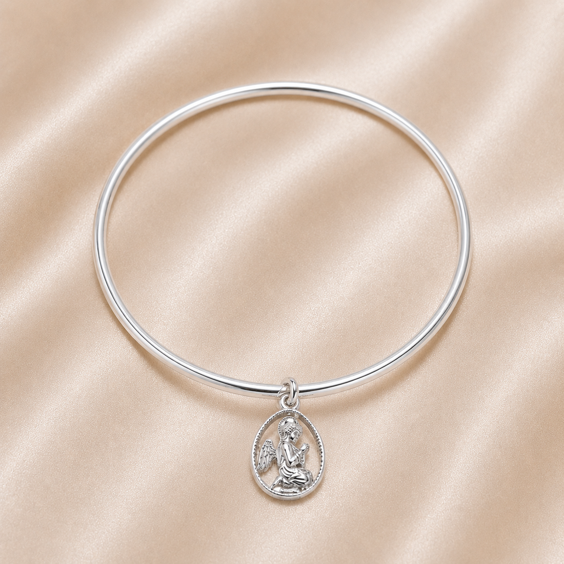 Silver bangle with a pendant on a beige satin background Sterling Silver | Guardian Angel Bangle