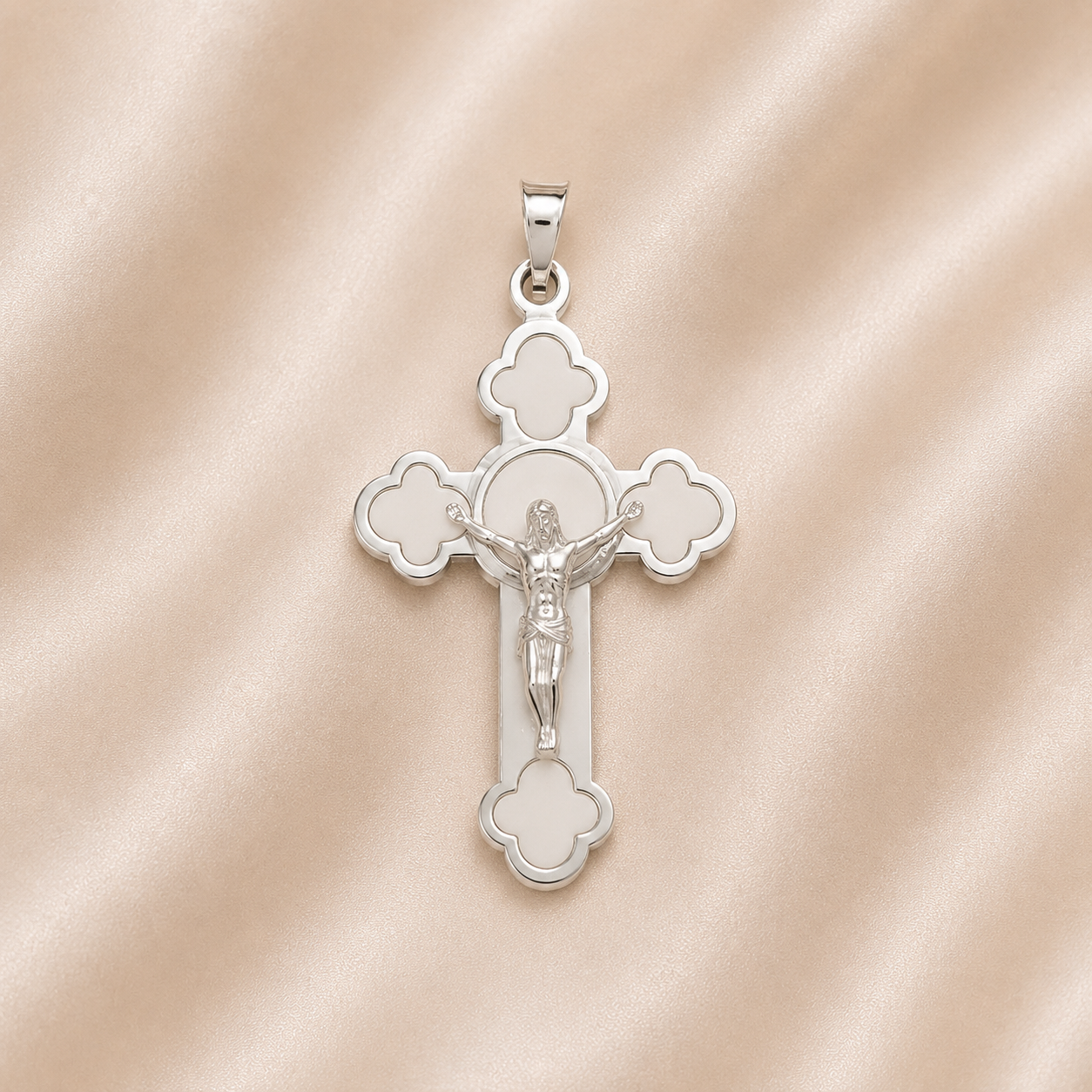Silver cross pendant with Jesus Christ figure on a pink satin  Sterling Silver | High Polished with Matte Finish Crucifix Pendant background