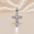 Silver cross pendant with diamonds on a soft pink satin background Sterling Silver | Large baguette and round CZ Cross Pendant