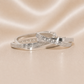 Two silver rings with intricate designs on a beige satin background Sterling Silver | Oval Greek Key Design Hoops