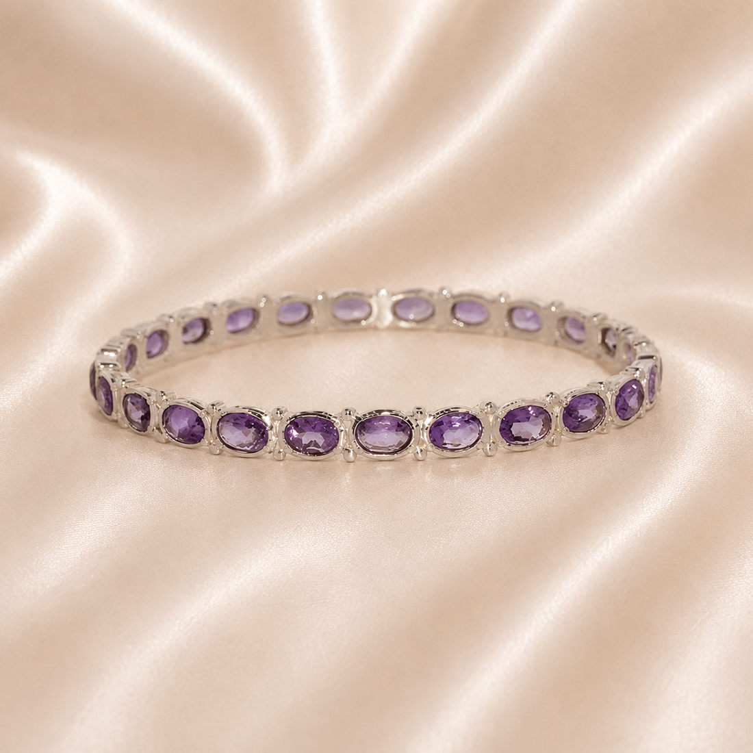 Silver bracelet with purple gemstones on a satin surface Sterling Silver | Round & Oval Amethyst Hinged Link Bangle Bracelet