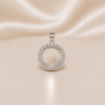 Silver circular pendant with embedded stones on a beige satin  Sterling Silver | Round Picture CZ Pendant Locketbackground