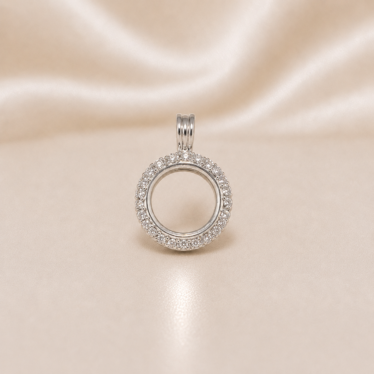 Silver circular pendant with embedded stones on a beige satin  Sterling Silver | Round Picture CZ Pendant Locketbackground