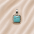 Turquoise stone pendant with silver frame on a beige fabric background Sterling Silver | Square Turquoise Pendant