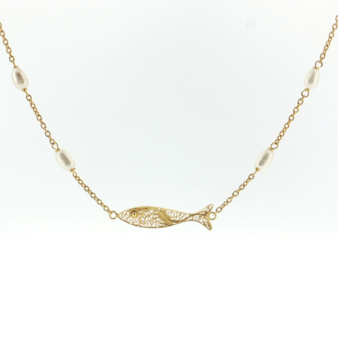 A delicate gold chain necklace featuring a central fish-shaped pendant with an openwork filigree design, accented by small white pearl beads spaced along the chain, set against a plain white background.