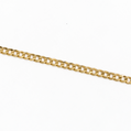 A close-up of a polished yellow gold curb chain running diagonally across a plain white background.