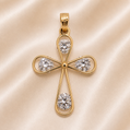 Gold cross pendant with diamonds on a beige background
