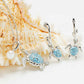 Silver-toned jewelry set featuring a necklace and matching earrings with sea turtle charms. The turtle pendants have light blue enamel-style detailing and are accented with small clear rhinestones.